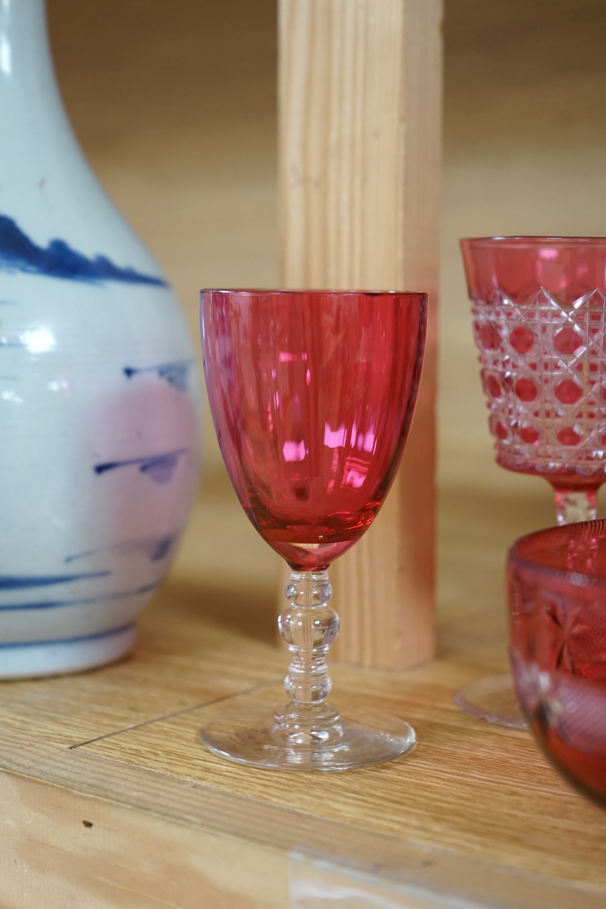 Two cranberry glass liqueur decanters and a collection of various glasses and a bowl, decanters 25cm high. Condition - good